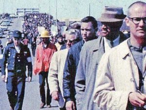 March for voting rights on Edmund Pettus Bridge heads for Montgomery, Alabama, in historic 1965 action. Today Democrats, Republicans fight to gerrymander away rival’s voting districts.