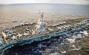 World’s largest aircraft carrier, USS Gerald R. Ford, in Mediterranean Sea March 22. U.S. Navy says its “warfighting effectiveness, lethality” is to defend U.S. rulers’ “interests in the region.”