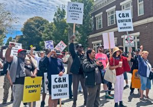 Striking C&H sugar workers at the Sugartown Festival in Crockett, California, July 19. Many there picked up hats, buttons and stickers to show support, donated to union strike fund.