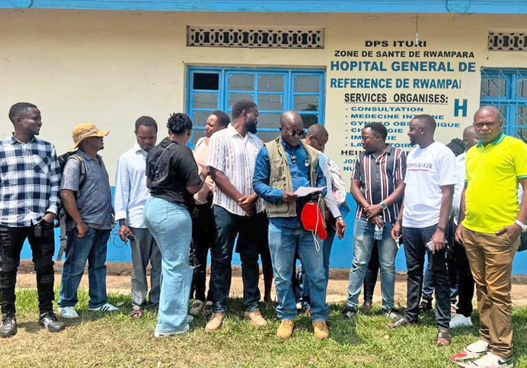 Medical workers at Ebola treatment center on strike over unpaid wages and abysmal working conditions, outside Rwampara hospital in Ituri, Democratic Republic of Congo, July 13.