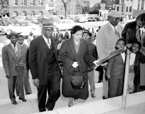E.D. Nixon escorts Rosa Parks, center, to courthouse in Montgomery, Alabama, March 19, 1956. Leaders of the powerful Black bus boycott organized by thousands there were on trial.