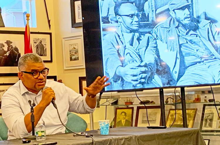 Panel discussion on Cuba and the Independence War in Guinea-Bissau and Cape Verde by Cuban revolutionary Víctor Dreke June 28 in Rhode Island. Abel Djassi Amado speaks in front of photo of Amílcar Cabral, leader of independence fight, and Cuban revolutionary Fidel Castro.