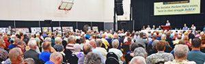 Audience of 300 at 2026 SWP international conference. “The Socialist Workers Party exists, born in class struggle. Build it!” says banner.