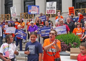 Some 50 American Postal Workers Union members and supporters rally at James A. Farley Post Office in New York July 28, part of nationwide protests against cuts in services, jobs.