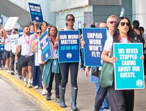 Some 200 WestJet flight attendants picket Toronto Pearson airport Aug. 2, part of 4,000 on strike demanding pay for all hours worked, including boarding and unboarding planes.