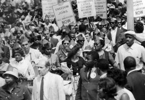 In August 1963, 250,000 joined March for Jobs and Freedom in Washington, D.C., the largest action ever against Jim Crow. Thousands more rallied in actions across the nation as impact of movement spread and grew.
