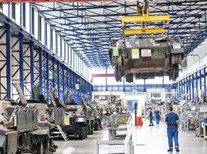 Berlin is sharply expanding militarization, including converting car plants to arms production. Above, production line at Rheinmetall tank factory, the largest in Europe, in Kassel, Germany.