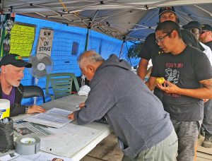 Strikers at National Steel Car in Hamilton, Ontario, sign up to picket Sept. 17. Incentive pay speedup, safety are key issues — seven workers have been killed on the job since the 1970s.