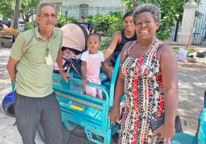 Washington’s trade blockade curtailed public transport, but Cuban government, people were able to open schools anyway. Above, electric tricycle driver, passengers in Havana in August.