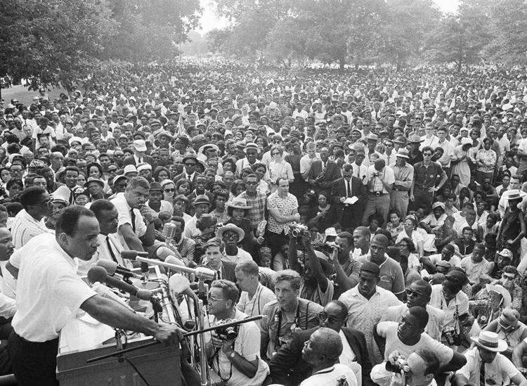 James Meredith, lower left, speaks to mass civil rights action in Jackson, Mississippi, June 26, 1966. After he was shot June 6 during his March Against Fear, thousands rallied to the fight.