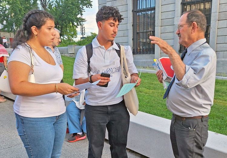 Joe Young, right, Communist League candidate for Quebec National Assembly, joins opponents of anti-Israel resolution being debated by City Council at Montreal City Hall Aug. 24.