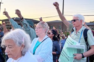 Ned Measel, right, joins hundreds of people July 1, 2025, outside Butler County Jail in Hamilton, Ohio, protesting detention of immigrant workers slated for deportation.