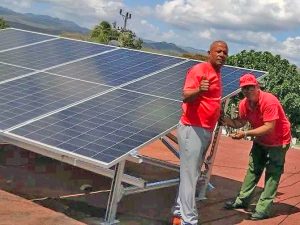 Workers install solar panels at healthcare facilities in Trinidad in March 2026, part of lessening impact of fuel shortages caused by U.S. rulers’ escalation of economic war against Cuba.