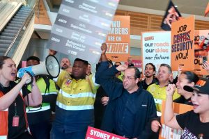 Members of Transport Workers Union rally at Qantas airline terminal in Sydney, Australia, Sept. 24. One-day strike by freight workers demanded raises, jobs, safe working conditions.