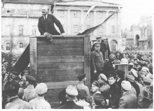 V.I. Lenin, leader of the Bolshevik Party that led world’s first socialist revolution, speaking in Moscow in 1920 to army leaving for Polish front. Leon Trotsky on stairs at right.