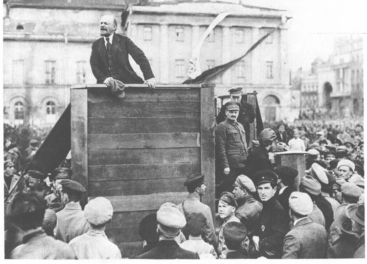 V.I. Lenin, leader of the Bolshevik Party that led world’s first socialist revolution, speaking in Moscow in 1920 to army leaving for Polish front. Leon Trotsky on stairs at right.